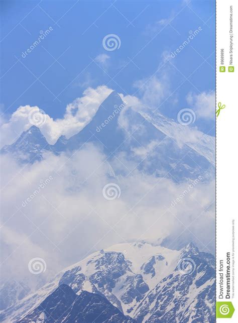 Himalaya Machapuchare Mountain Peak In Cloudy Blue Sky Nepal Stock