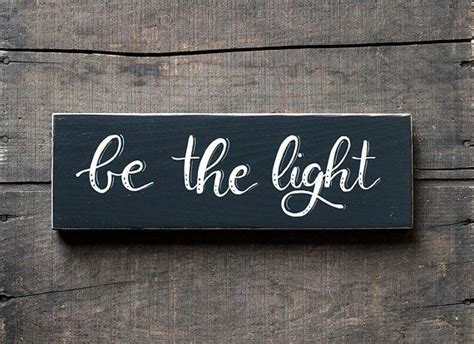 Set A Motivational Tone With This Hand Lettered Be The Light Wood Sign