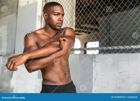 African American Male Athlete Shirtless Muscular Body Stretching