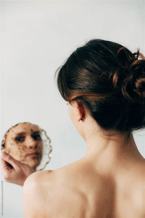 Woman Looking At Camera Through Mirror By Alina Hvostikova