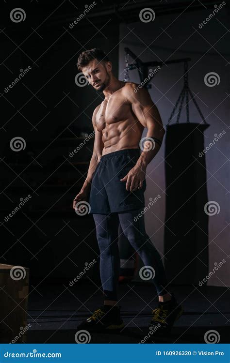 Professional Bodybuilding Man Posing In Front Of The Camera Showing His