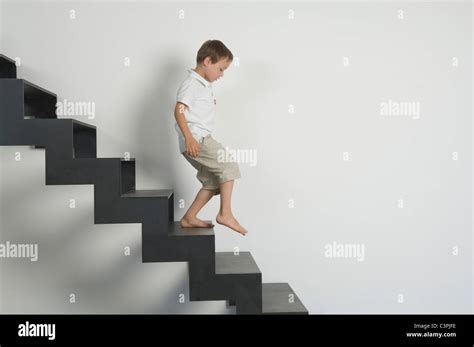 Boy Walking Down Stairs Stock Photos And Boy Walking Down Stairs Stock