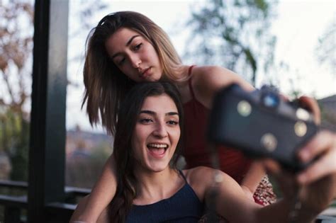 Premium Photo Lesbian Couple Taking Selfie In Balcony