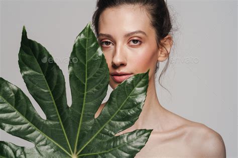 Beautiful Half Naked Woman Posing With Green Leaf On Camera Stock Photo