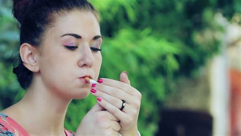 Beautiful Woman Lights A Cigarette Stock Footage Video