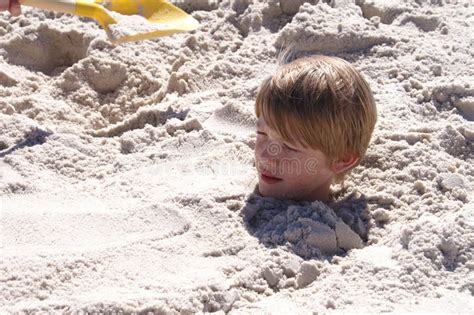 Boy Buried In Sand Stock Images Image 34002464