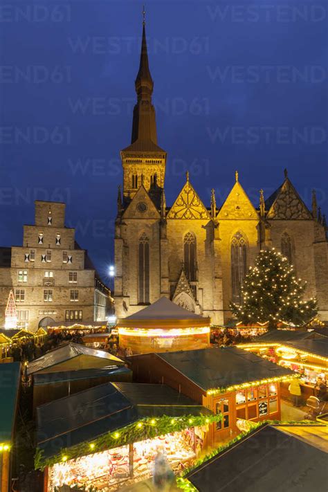 Enjoying the osnabruck christmas market. Germany, Osnabrueck, Christmas market, weighing house and St. Mary's Church - WIF003202 ...