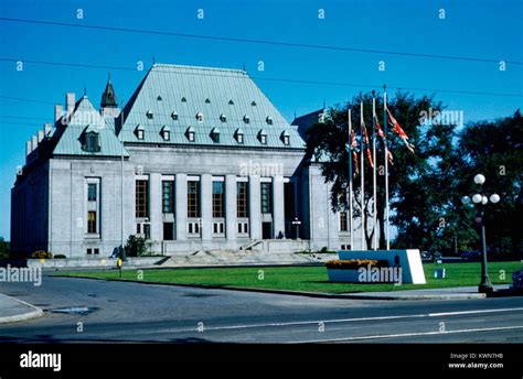 Facade Of The Supreme Court Of Canada With Canadian Flags Flying