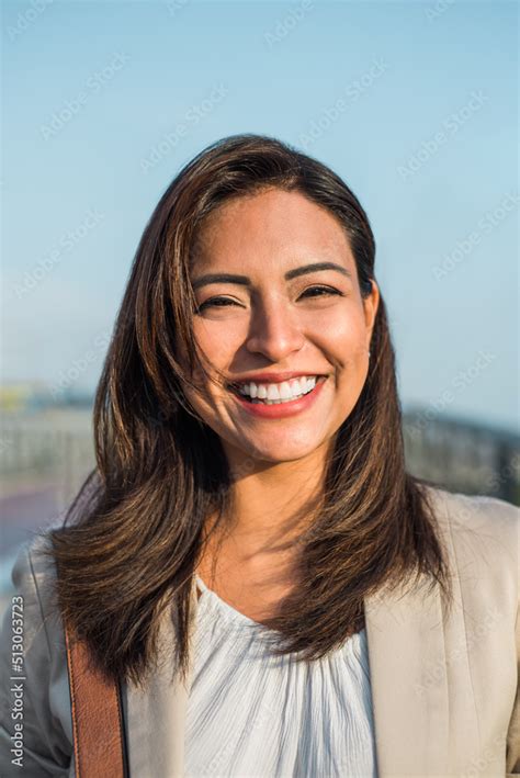 Portrait Of A Beautiful Latin Woman Smiling Outdoors With Sunset Light