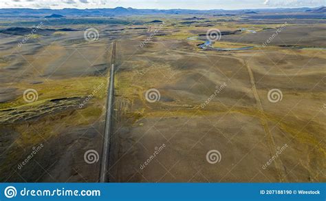 Aerial Shot Of A Long Narrow Road Between Fields In Iceland Stock Photo