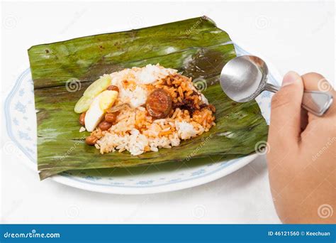 Eating The Traditional Banana Leaf Wrapped Nasi Lemak Stock Photo