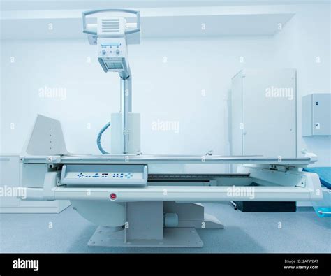 Modern Medical Room With Automatic X Ray Machine And Couch Stock Photo