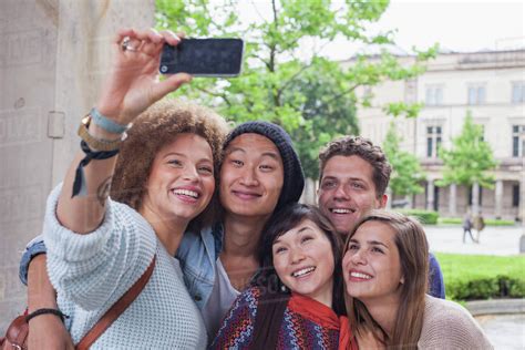 Smiling Young Woman Taking Selfie With Multi Ethnic Friends Berlin