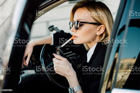 Stylish Blonde Woman Holding Lighter With Fire While