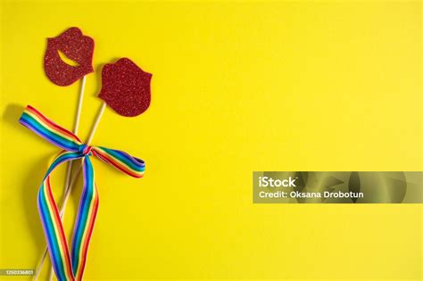 Paper Kisses On A Stick Are Tied With A Rainbow Ribbon On A Yellow Background Lesbians Lgbt