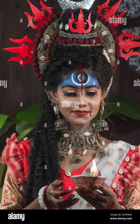 portrait of beautiful indian girl of durga idol agomoni concept indoor photo wearing traditional