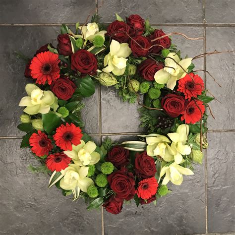 Red And Green Contemporary Wreath Design Funeral Flowers Tribute
