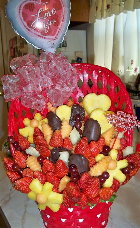A Red Basket Filled With Lots Of Different Types Of Fruit And Candy On