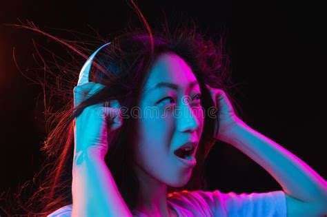 Asian Young Womanand X27s Portrait On Dark Studio Background In Neon