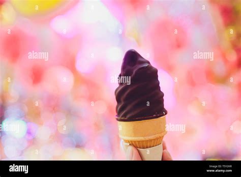 Hand holding chocolate triple scoop ice cream Stock Photo - Alamy
