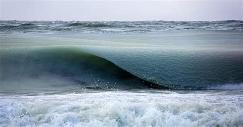 Giant Freezing Waves Infused With Ice Slowly Roll In Off The Coast Of