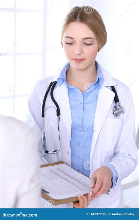 Young Woman Doctor And Patient At Medical Examination At Hospital
