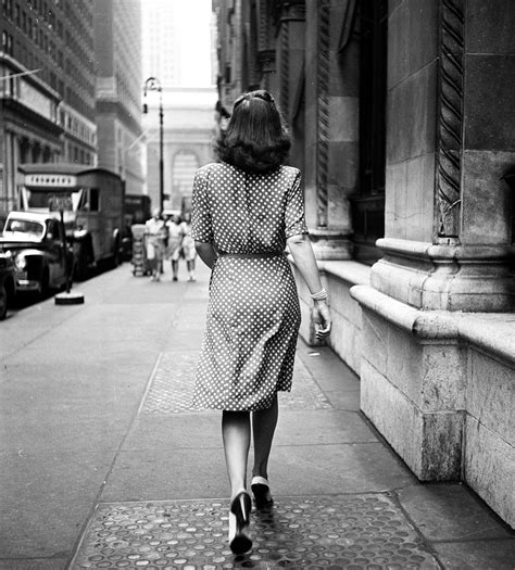 A Woman Walks Down The Sidewalks Of New York City In A Polka Dot Dress