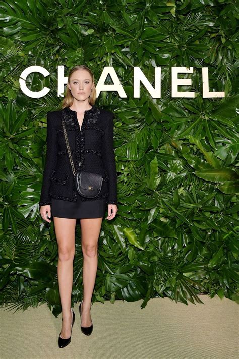 Behind the portraits is a podium with draped ribbons and flowers carved into it. Maika Monroe - Chanel Dinner Celebrating Gabrielle Chanel ...
