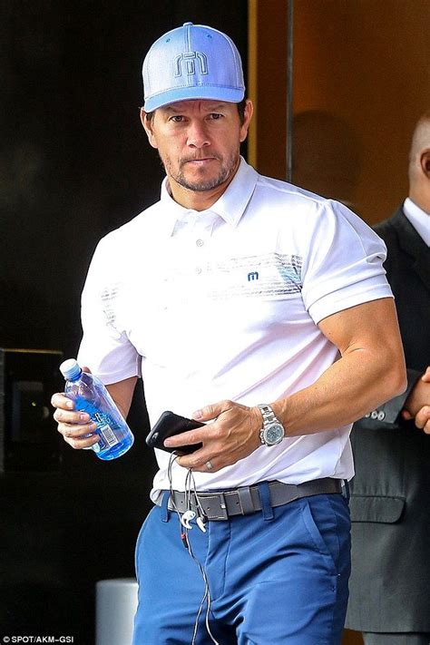 Muscly Mark Wahlberg Showcases His Bulging Biceps In Tight Polo Shirt