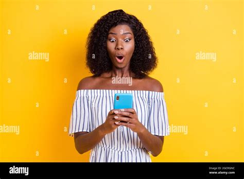 Photo Of Impressed Dark Skin Girl Open Mouth Staring Phone Unexpected Bad Fake News Isolated On