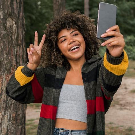 Premium Photo Smiley Woman Taking Selfie While Camping Outdoors