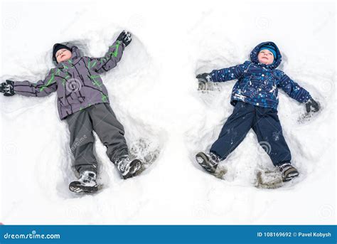 Two Little Siblings Kid Boys In Colorful Winter Clothes Making S Stock