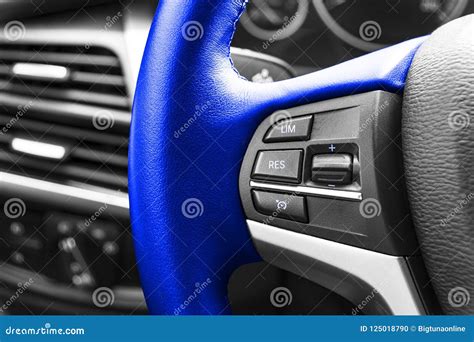 Cruise Control Buttons On The Blue Steering Wheel Of A Modern Car Car