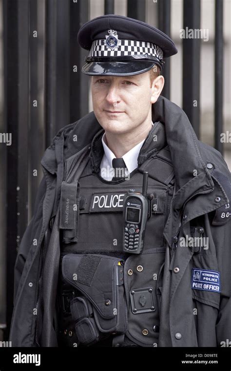 London Policeman Wearing Bullet Proof Vest Standing Guard In Front