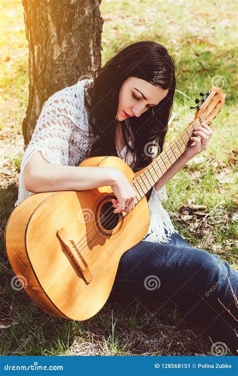 Beautiful Woman Playing An Acoustic Guitar Outdoor Stock Image Image Of Artist Brunette