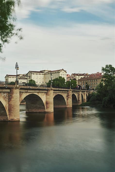 Stone Bridge Over A River In A Quaint European Medieval Town Photograph