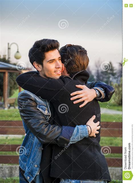 Happy Male Friends Hugging In Sunlight Stock Image Image