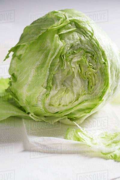 A Partly Sliced Fresh Iceberg Lettuce Stock Photo Dissolve