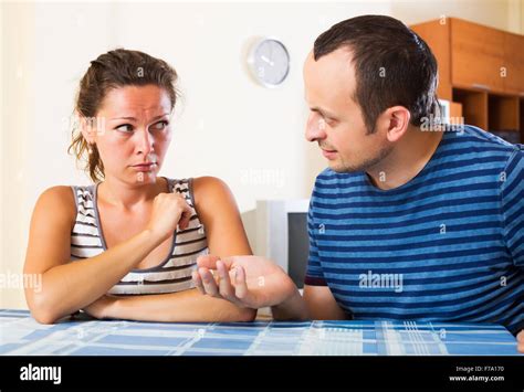 Sad Partner Asking Another For Forgiveness At Home Stock Photo Alamy