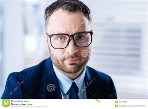 Elegant Young Man Looking Calm While Wearing New Glasses Stock Photo