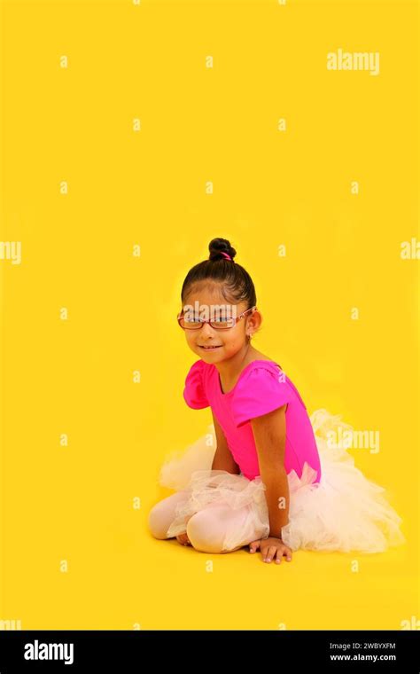 4 Year Old Brunette Latina Girl With Eyeglasses Dressed In Pink Leotard