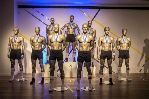 A Group Of Mannequins With Medals Around Their Necks