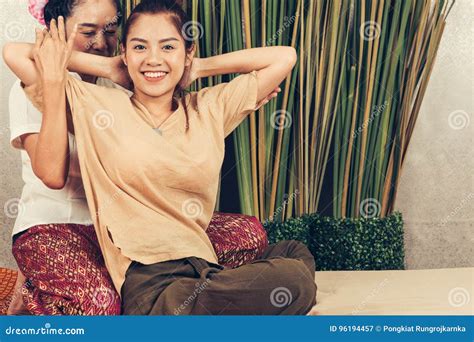 Young Girl Get Thai Style Massage By Woman For Body Therapy Stock Image