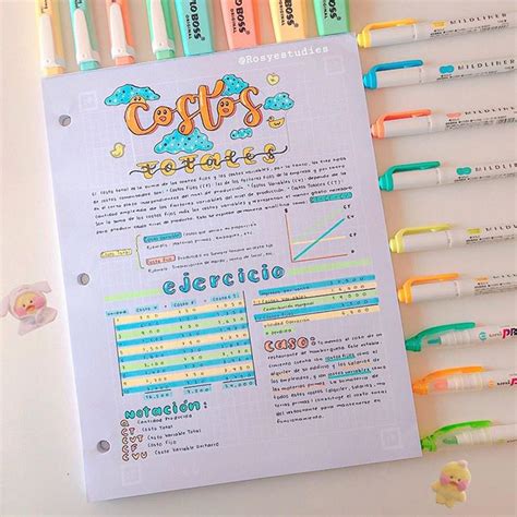 Several Different Colored Pens Are On Top Of A White Paper With The