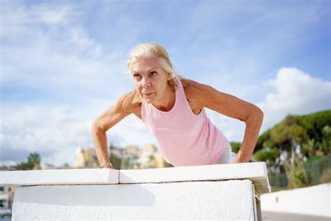 Mature Woman Working Strength Training Push Ups Against Sky With Copyspace Stock Image Image