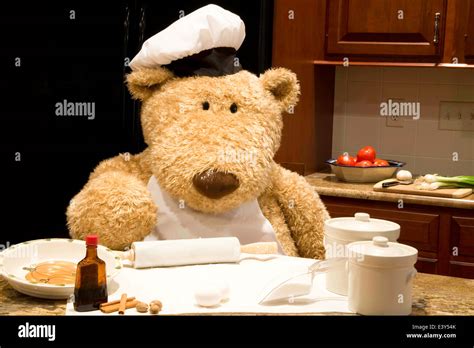 Oversized Teddy Bear Dressed In Chefs Apron And Hat In The Kitchen