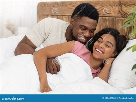 Happy Romantic Black Couple Cuddling In Bed Stock Image 197483881