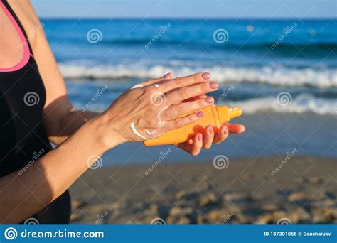 Close Up Of Woman Applying Suntan Lotion Sand Beach Blue Sea