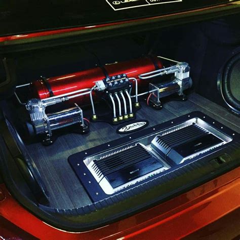 The Inside Of A Car With Speakers And Other Electronics In Its Trunk Area