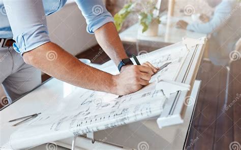 Architect Drawing A Plan For A Building Project Inside His Office